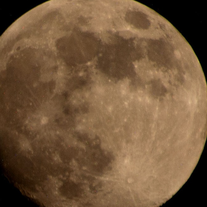 A golden waxing gibbous moon, photographed from the International Space Station — image credit NASA